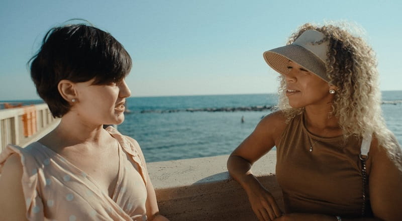 Ashley and Laura sitting by the seaside