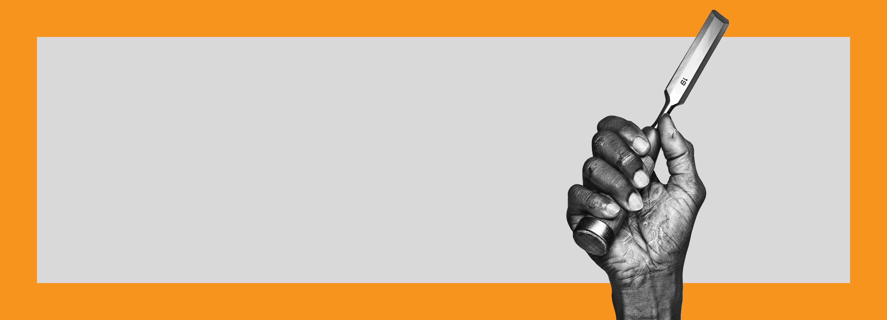 Black and white photograph of a hand with moderate to severe hand eczema holding a chisel.