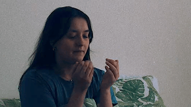 Photograph of a Emma, real patient with Chronic Hand Eczema, looking at her hands