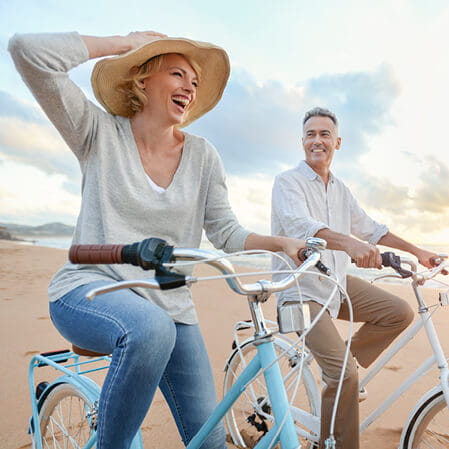 Couple riding bikes outside