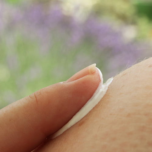 Finger applying a topical eczema treatment