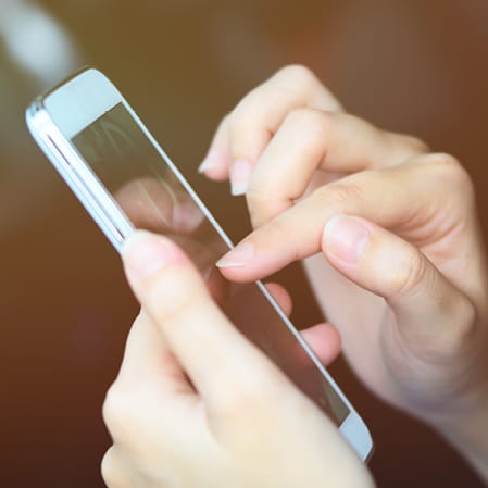 Patient researching eczema on a mobile phone