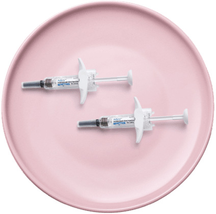 Image of Adbry™ (tralokinumab-ldrm) syringes on a plate