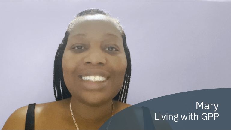 Mary, living with GPP, smiling in a video about inspiring others